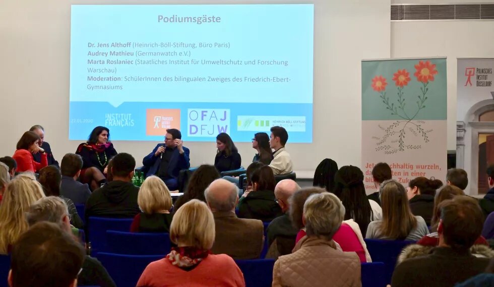 MArta Roslaniec, Audrey Mathieu, Dr. Jens Althoff und Schüler*innen des Friedrich-Ebert-Gymnasiums diskutieren vor einem Publikum im Institut français Bonn über Klimaschutz.